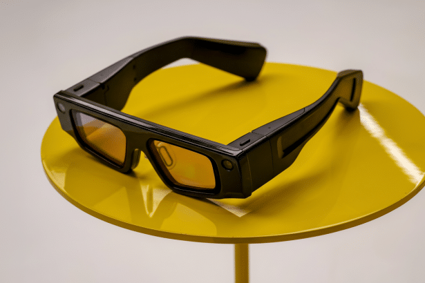 Black smart glasses with orange- tinted lenses resting on a bright yellow circular table against a light gray background.