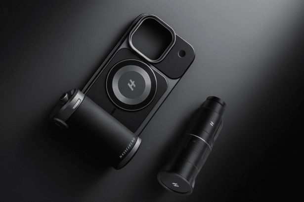 A professional shot of a smartphone with a camera attachment and a separate camera lens, all in a sleek black design .