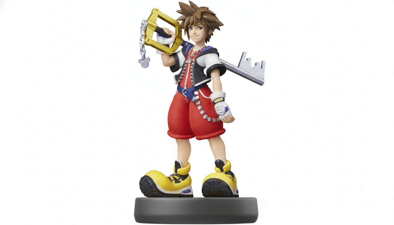 An Ami ibo figure of Sora from Kingdom Hearts, standing on a dark grey base , holding a golden keyblade over his right shoulder. He is depicted in his iconic red shorts, black and white jacket, and oversized yellow shoes.