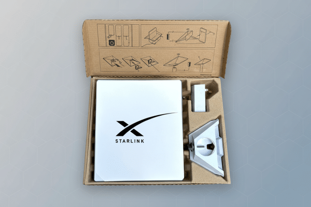 ** Star link satellite internet kit with dish , stand, and power adapter in open packaging, presented with a professional gray geometric background. **