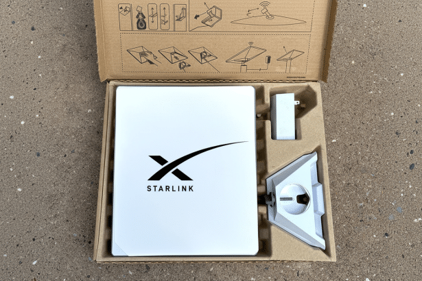 A Starlink satellite internet dish and its stand are neatly packaged in a cardboard box, ready for setup, with setup instructions printed on the insid