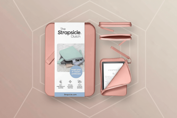 A professional overhead shot of a pink The Strapsicle Clutch e- reader case with an e- reader partially inserted, showcasing its protective design and