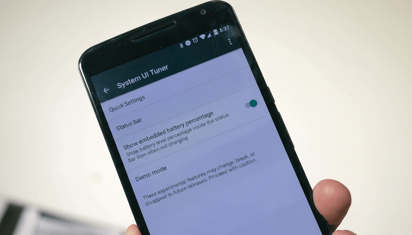 A hand holding a smartphone displaying the System UI Tun er settings with Show embedded battery percentage enabled.