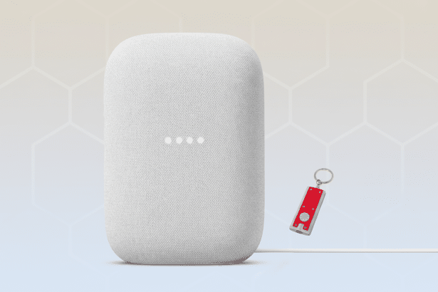 A white Google Nest smart speaker with an attached cable and a red and silver keychain with a white ring on a background with soft gradient and hexagonal patterns.
