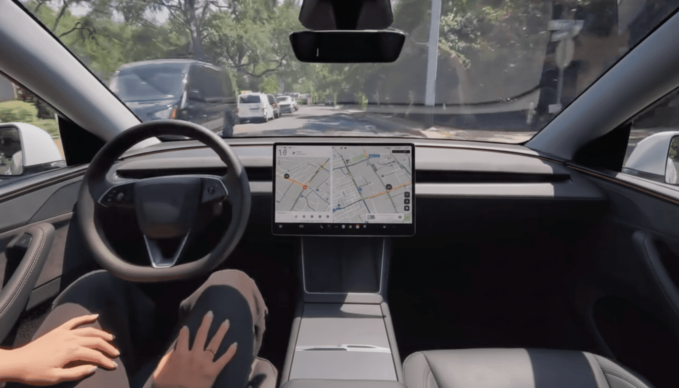 Interior view of a Tesla car with a driver' s hands on the wheel and a large central screen displaying a navigation map.