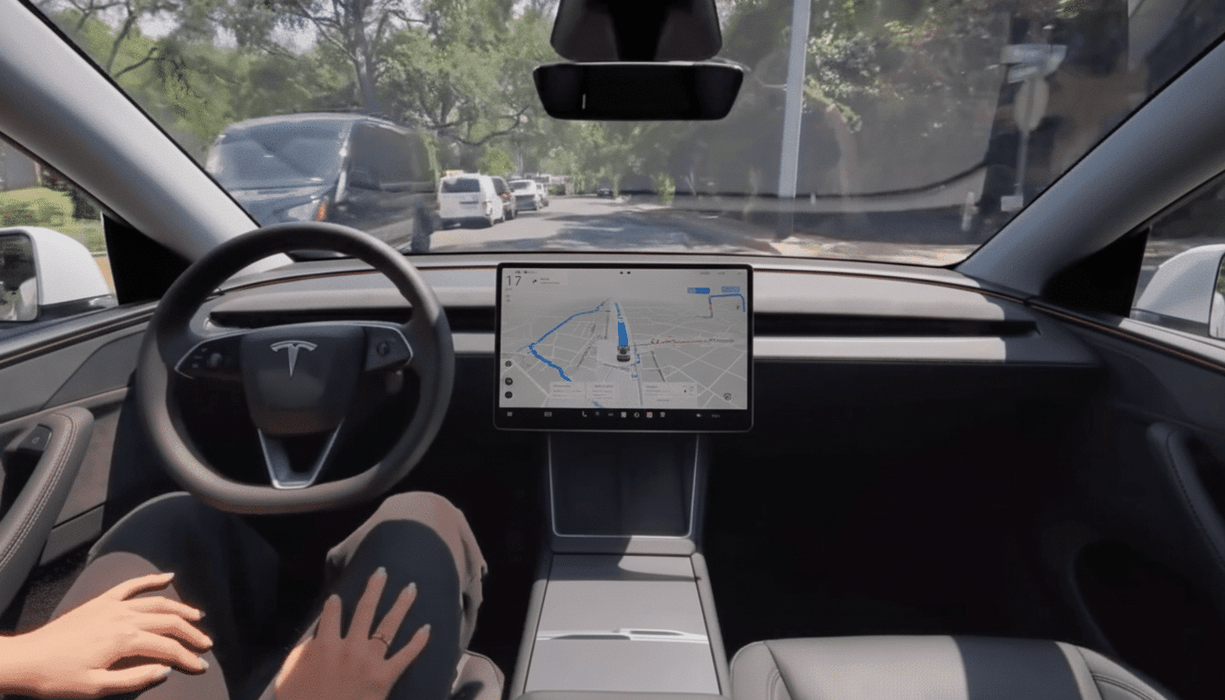 Interior view of a Tesla car with a driver's hands on their lap, showing the steering wheel, dashboard , and a central screen displaying a navigation map. The car is on a tree -lined street with other vehicles .