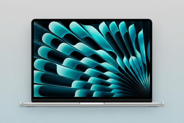 A silver laptop with a screen displaying a teal and black abstract wallpaper, set against a light grey background with a faint hexagonal pattern.