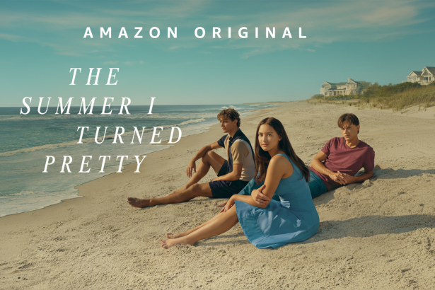 Promotional image for The Summer I Turned Pretty showing three young people sitting on a sandy beach by the ocean with houses in the background . The text AMAZON ORIGINAL THE SUMMER I TURN ED PRETTY is overlaid.