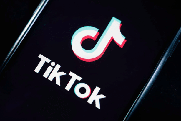 The TikTok logo displayed on a smartphone screen, resized to a 1 6:9 aspect ratio while maintaining the original dark background. Filename : tiktoklogo smartphone 16 9. png