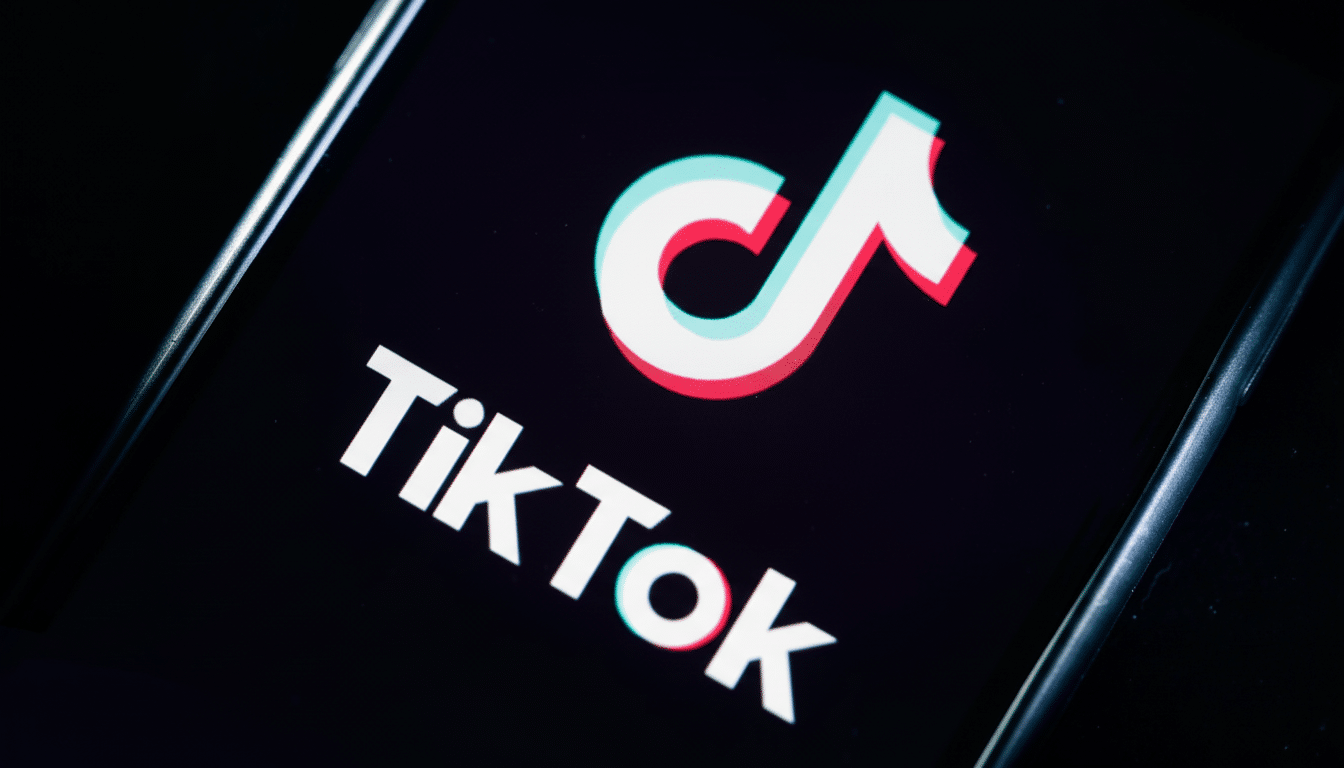 The TikTok logo is displayed prominently on a smartphone screen, featuring its distinctive white music note icon with red and blue accents against a black background.