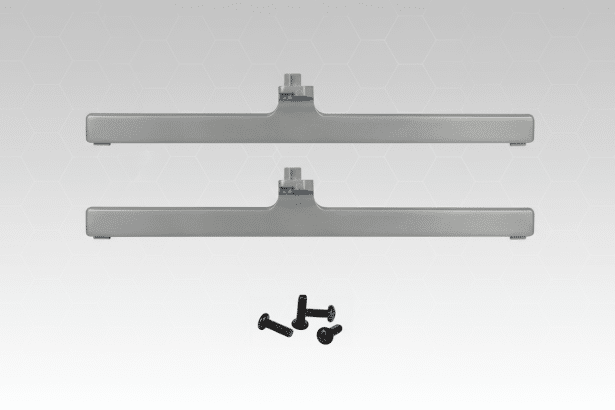 The two silver television stand feet and four black screws are set against a professional background