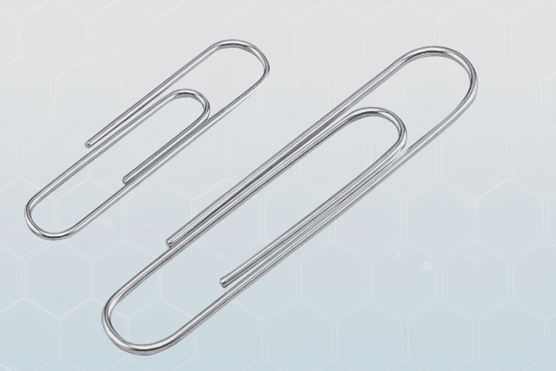 Two silver paper clips, one larger than the other, are presented against a subtle gray background with a faint hexagonal pattern.