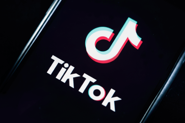 Here is your resized and enhanced image: TikTok logo displayed on a smartphone screen, against a da