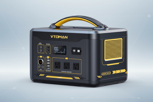 A professional image of the VTOM AN Jump 1 800 portable power station, black and yellow , featuring multiple input and output ports, a digital display, and a yellow carrying handle, presented against a clean gray gradient background. Filename : vt omanjump 1800 power station.png