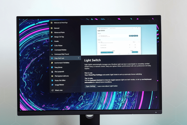 A monitor displaying the PowerToys Light Switch feature with a professional flat design background.