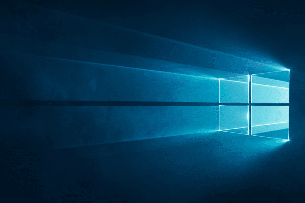 alt : The Windows 10 logo, a glowing blue four -pane window, against a dark blue background with lig