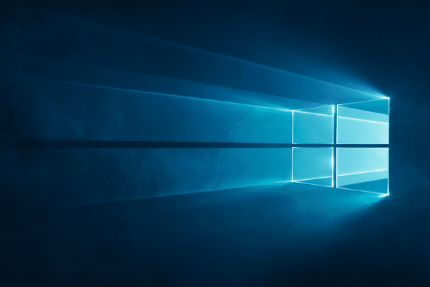alt text: The Windows logo rendered with bright blue light emanating from behind it, set against a