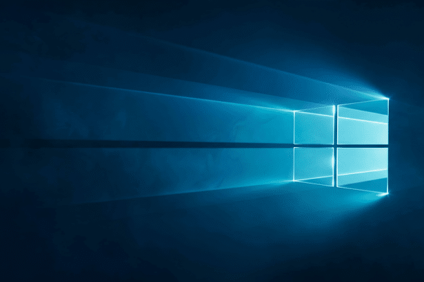 The Windows logo rendered in light blue against a dark blue background , with light rays extending from the logo.
