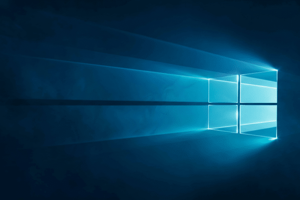 A dark blue background with a bright , glowing Windows logo in the center, radiating light rays to the left.