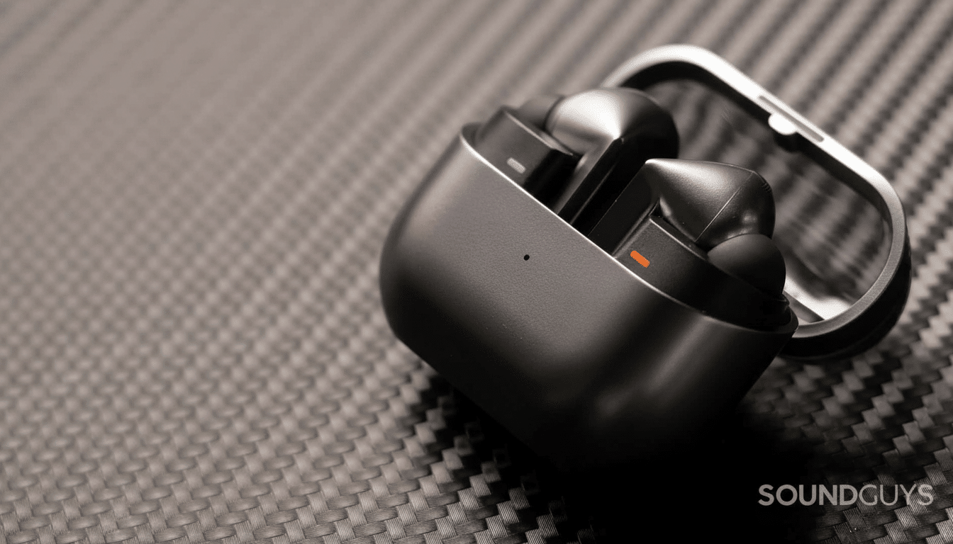 Black wireless earbuds in their open charging case, displayed on a textured dark gray surface. Filename : wireless earbuds case .png