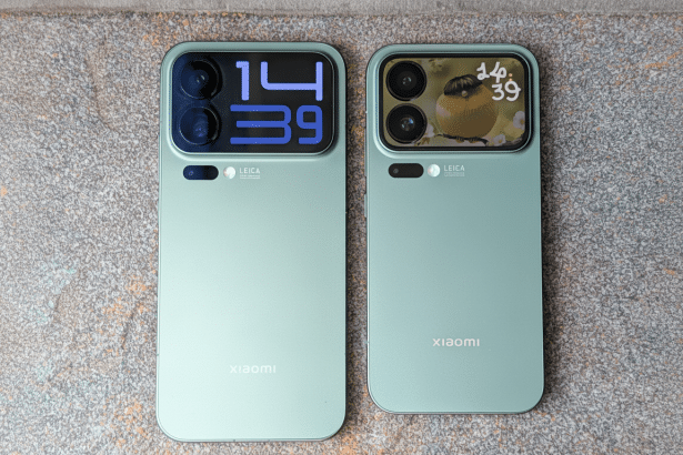 A top -down view of two light green Xiaomi phones with prominent camera modules , laid on a speckled grey surface. The left phone displays 14 3 9 in blue digital numbers , while the right phone shows a small bird and 1 4 39 in a more stylized font. Both phones feature LEICA branding .