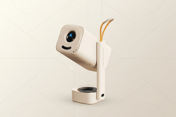 A modern beige portable projector with a black lens and a small orange strap , set against a subtle, light beige geometric pattern background. Filename : beigeportable projector. png