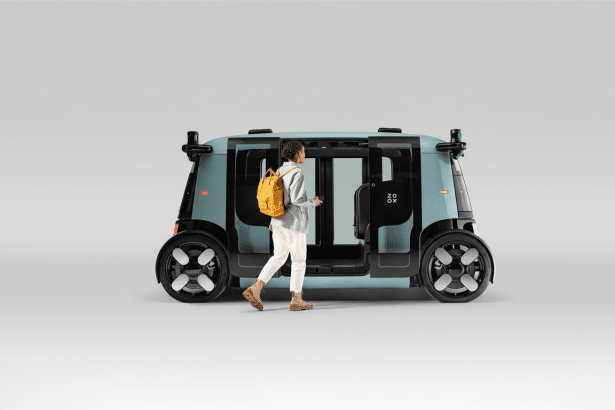 A person with a yellow backpack walking towards the open door of a light blue Zo ox autonomous vehicle on a plain light gray background. Filename : zoox vehicle person entering.png