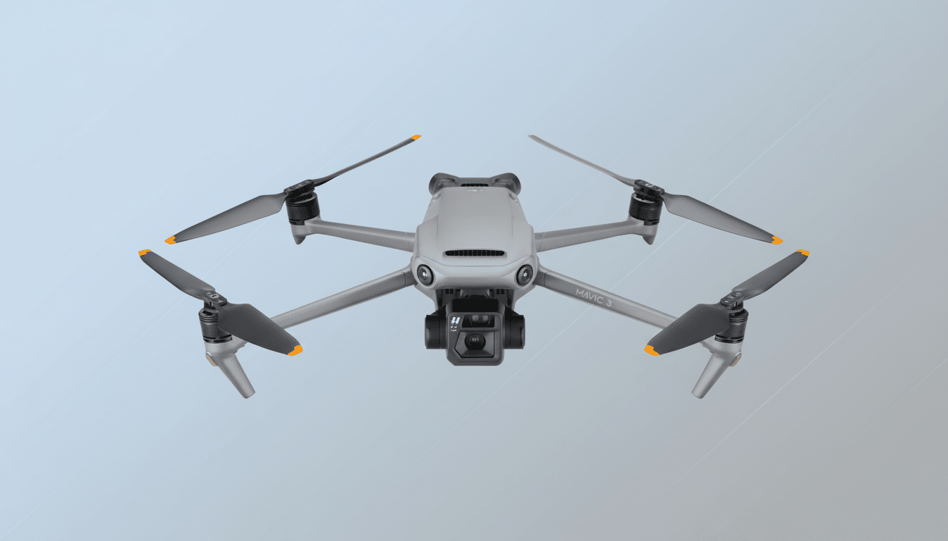 A gray DJI Mavic 3 drone with orange-tipped propellers is centered against a soft, light blue and gray gradient background.