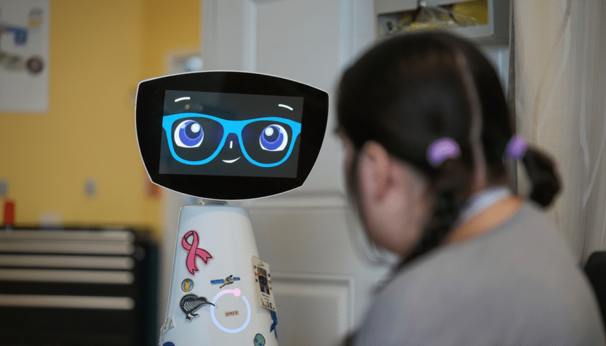 A young girl with braided hair and purple hair ties looks at a white robot with a screen displaying a cartoon face wearing blue glasses.