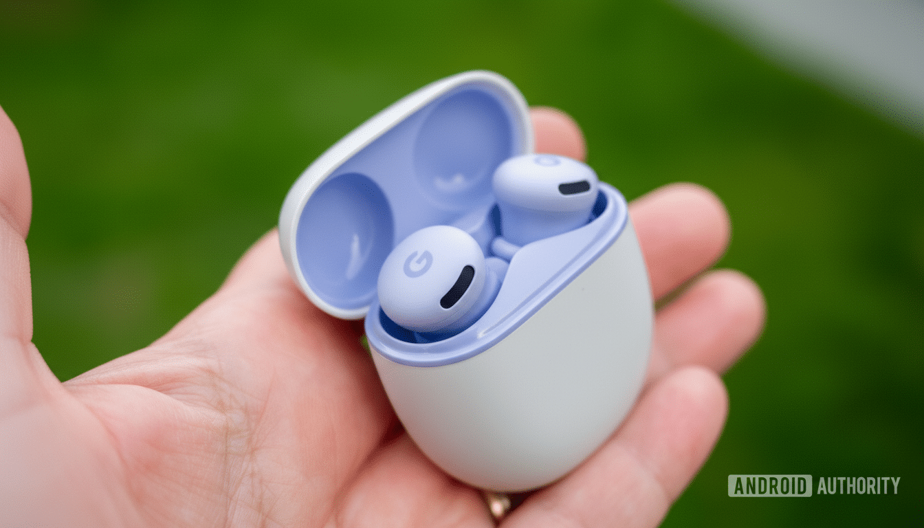 A hand holding an open white and lavender Google Pixel Buds case with the earbuds inside, set against a blurred green background.