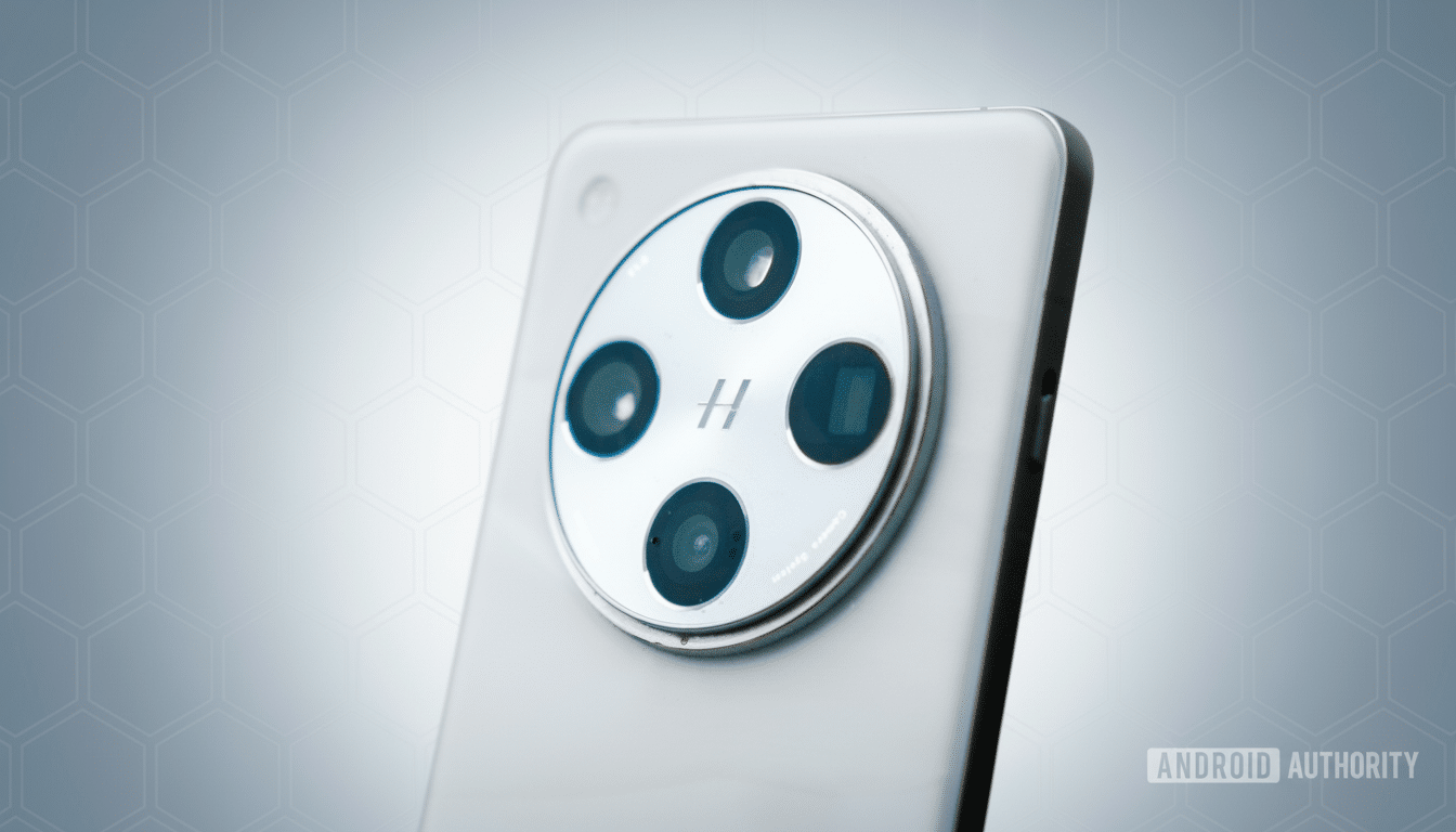 A close-up, professional shot of the back of a silver smartphone, featuring a prominent circular camera module with four lenses and an H logo in the center, set against a subtle, light gray patterned background.