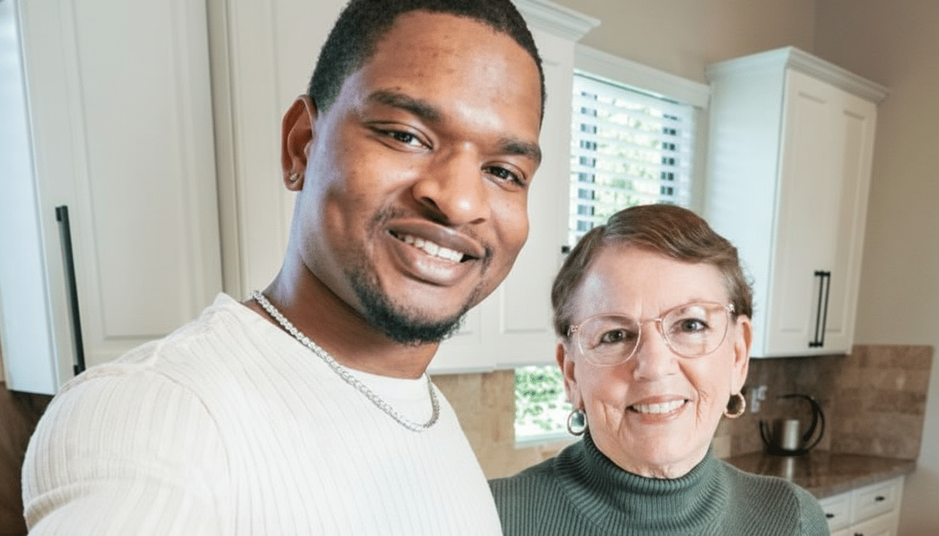 A man and a woman smiling in a kitchen.