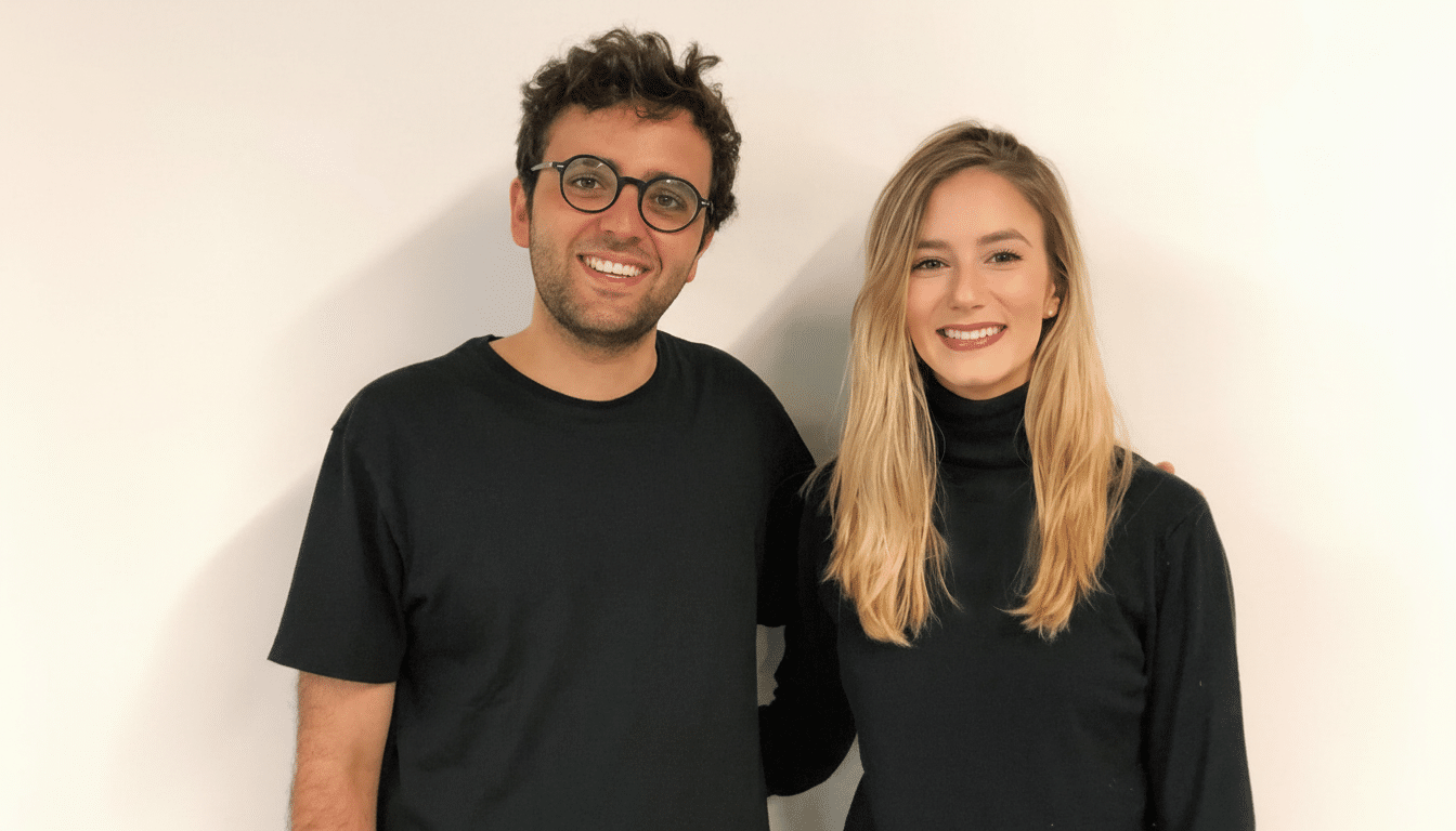 A man and a woman smiling at the camera, resized to a 16:9 aspect ratio.