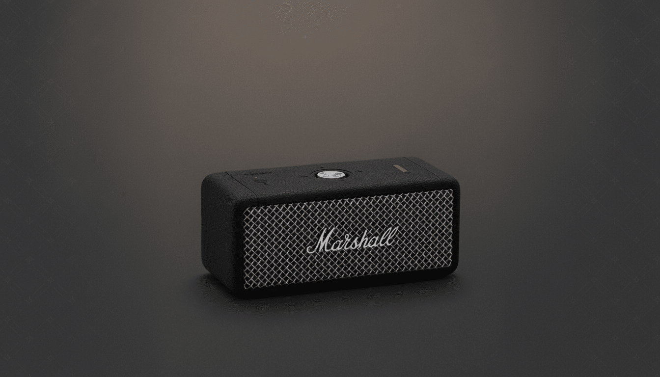 A black Marshall Emberton II portable Bluetooth speaker with a textured finish and a silver control knob, presented on a dark gray background with a subtle pattern.