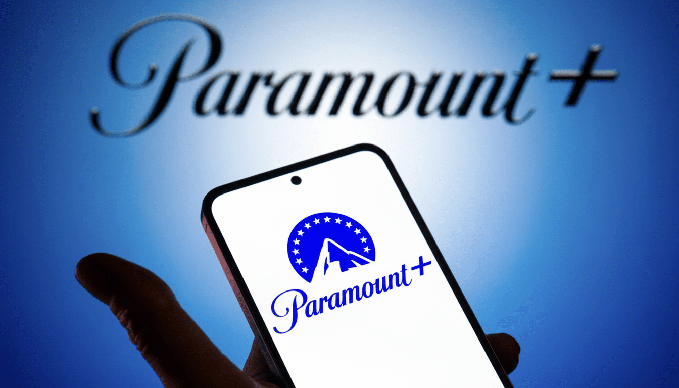 A hand holding a smartphone displaying the Paramount+ logo, with the Paramount+ text logo blurred in the background.