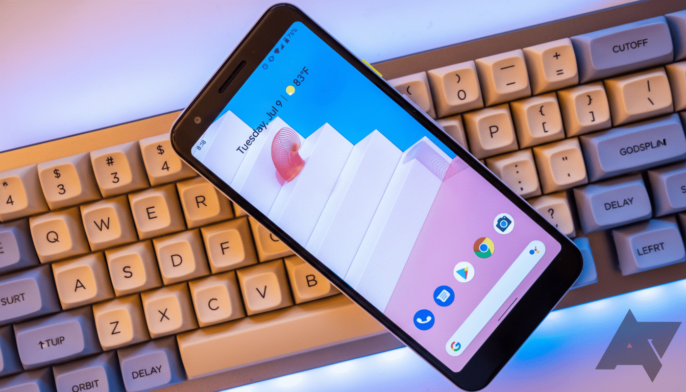 A smartphone displaying its home screen with app icons and a date/temperature widget, resting diagonally on a mechanical keyboard.