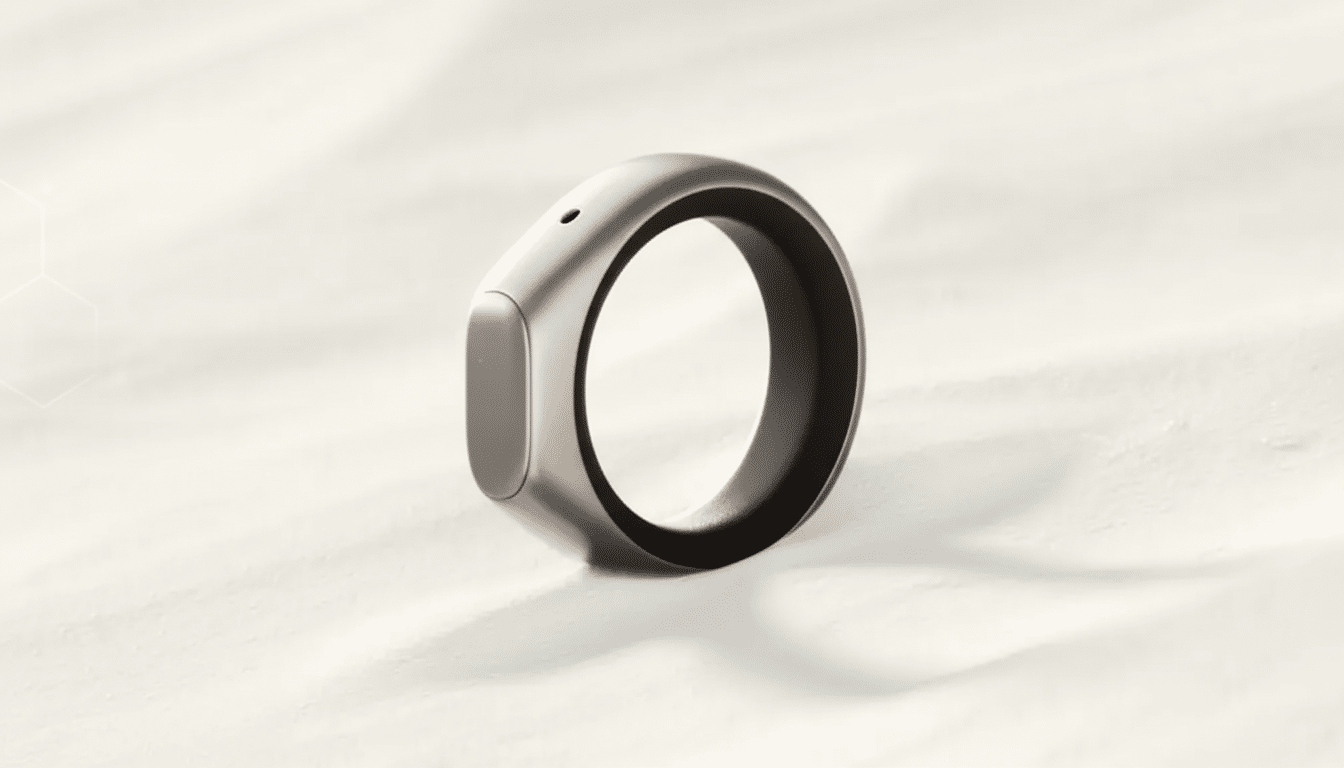 A sleek, silver smart ring with a dark interior band, presented on a clean, light background with subtle geometric patterns.