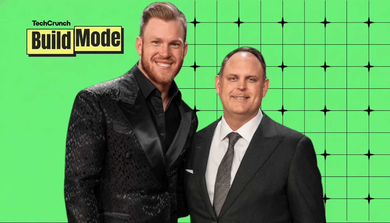 Two men, one with a beard and wearing a patterned suit, and the other in a dark suit and tie, stand smiling against a bright green background with a black grid pattern. The TechCrunch Build Mode logo is in the upper left corner.