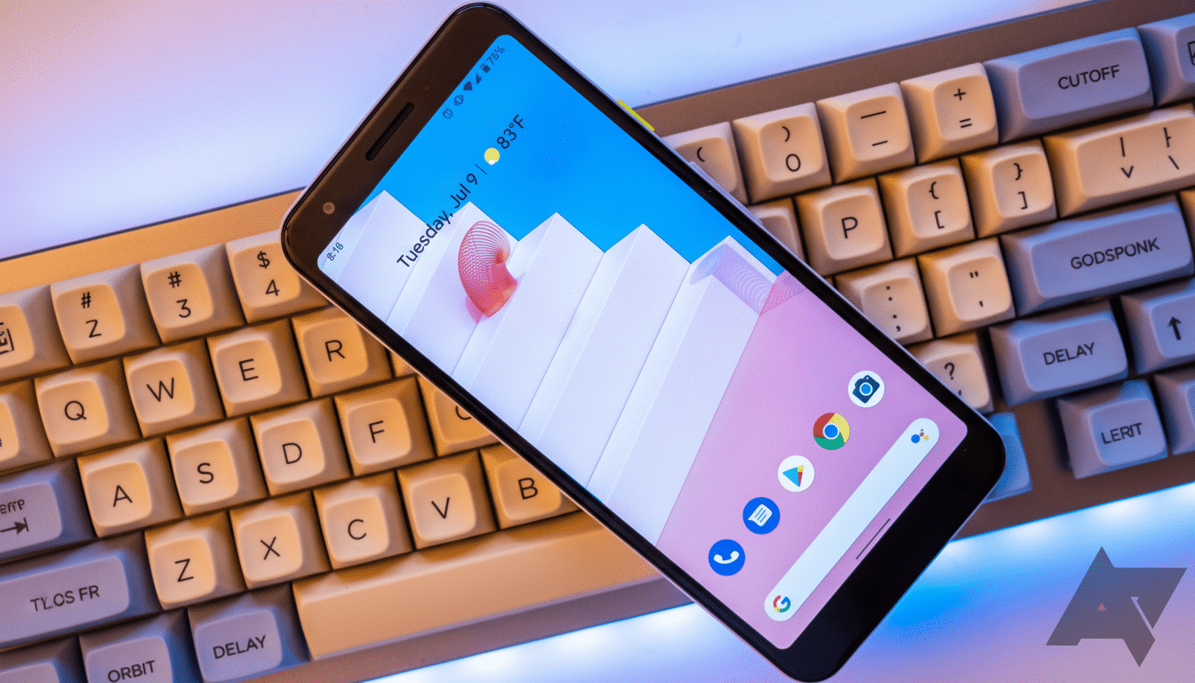 A smartphone displaying a home screen with app icons and a date/temperature widget, resting diagonally on a mechanical keyboard.