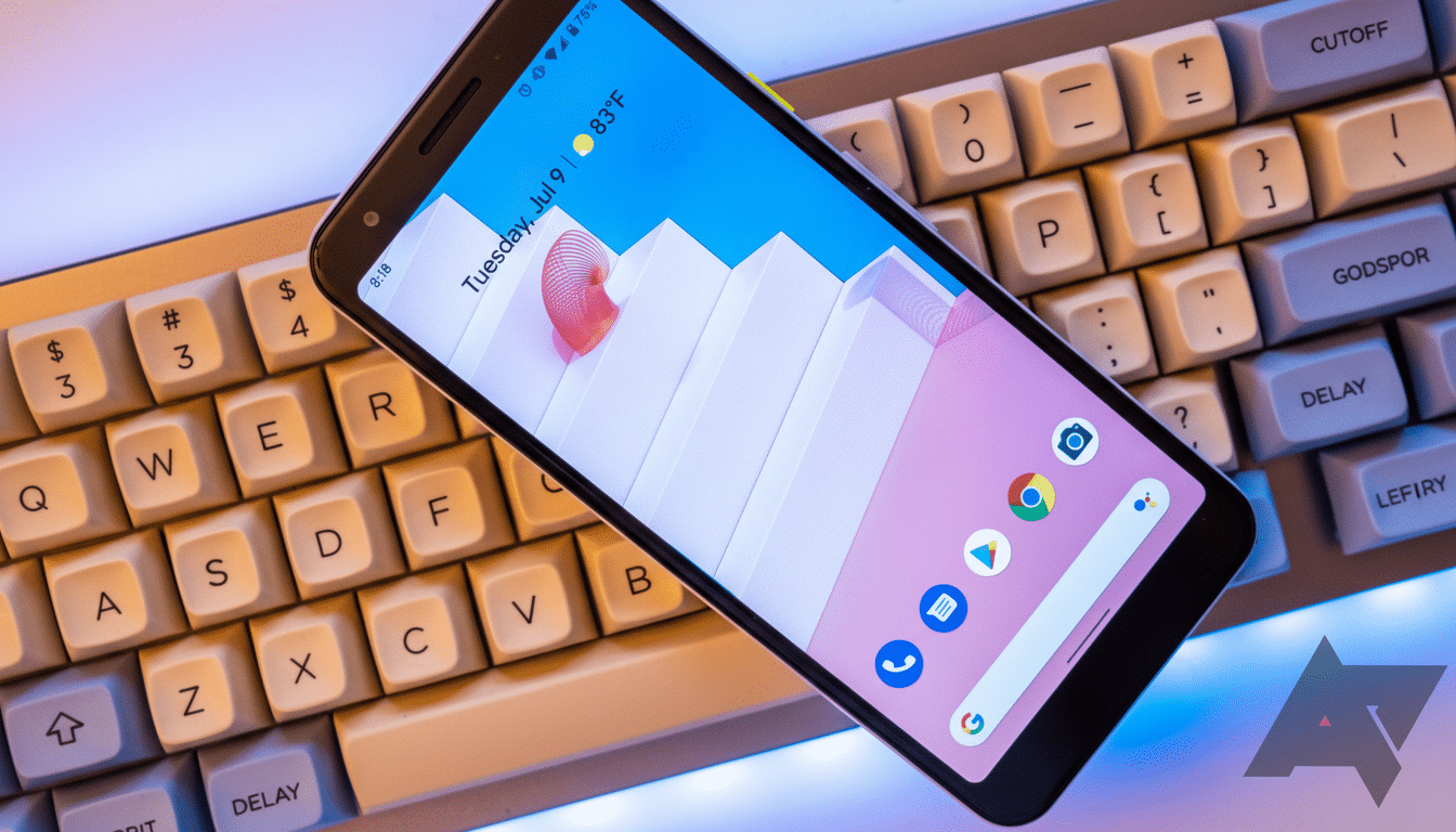 A smartphone displaying a home screen with app icons and a date/temperature widget, resting diagonally on a mechanical keyboard.