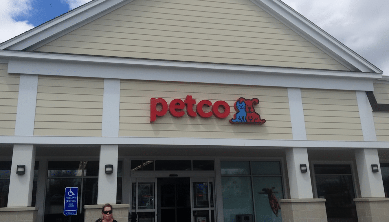 The Petco store entrance with its red logo and a person in sunglasses visible at the bottom left.