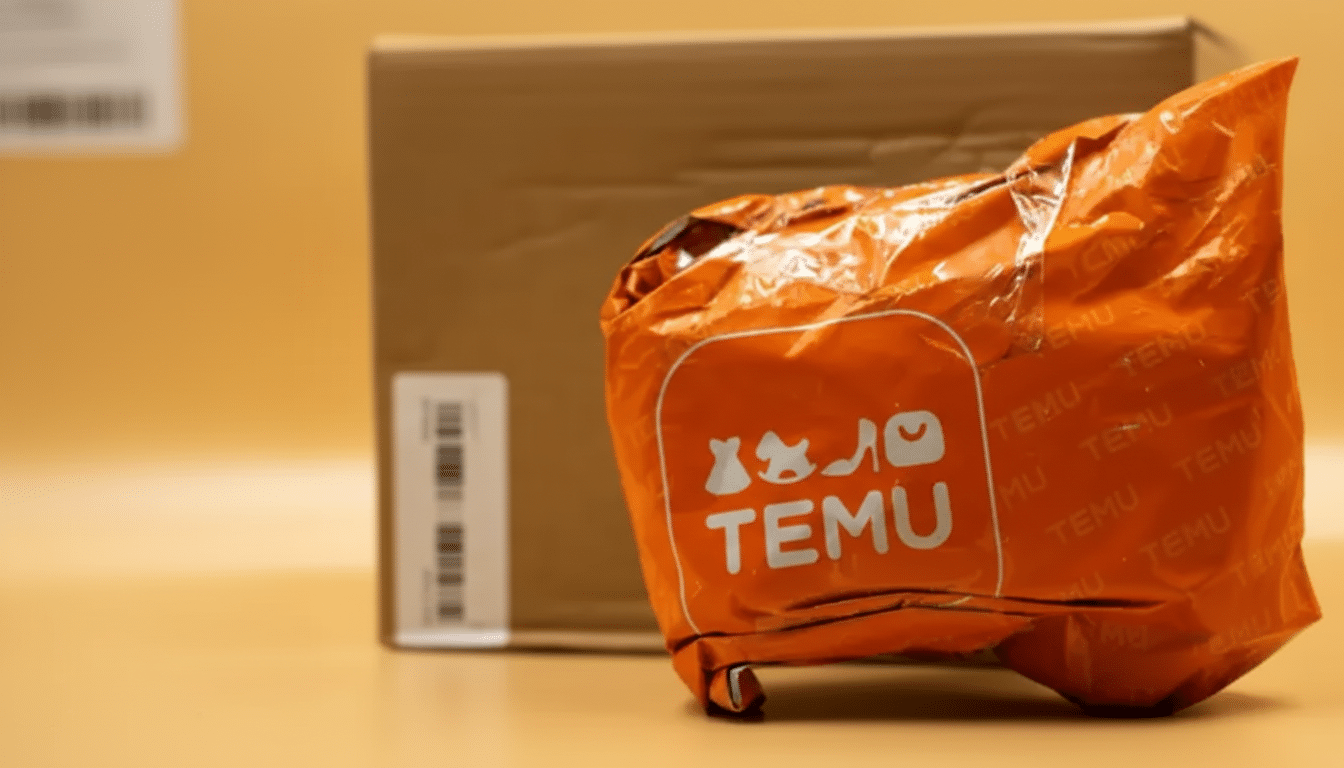 A wrinkled orange Temu package sits in the foreground with a brown cardboard box in the background, all on a light orange surface.