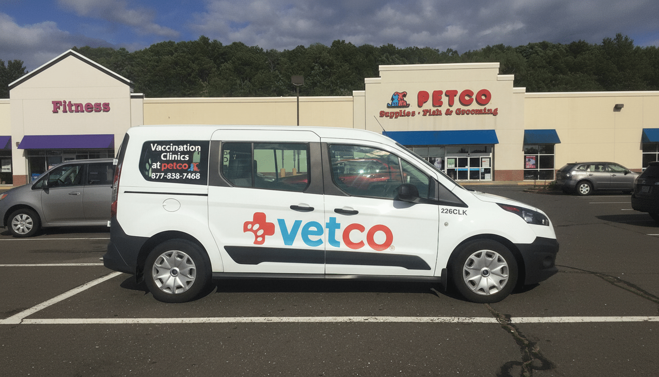 A white Vetco van parked in a Petco parking lot.