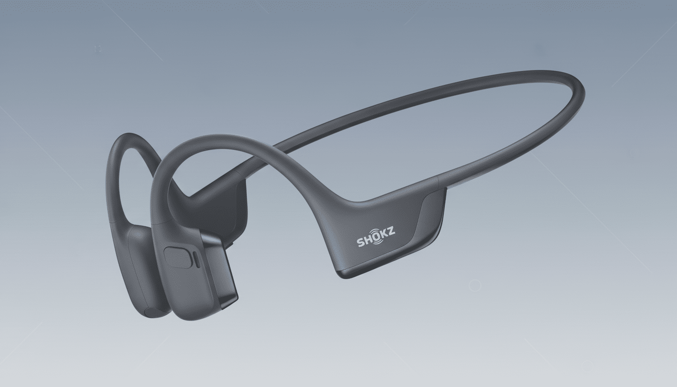 A pair of dark gray Shokz bone conduction headphones on a professional flat design background with soft gray gradients.