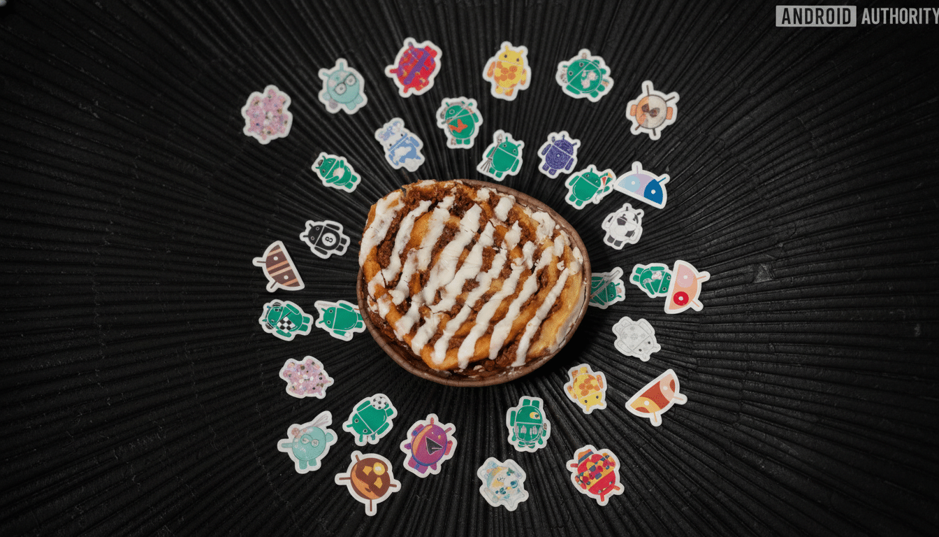 A cinnamon roll with white icing in a bowl, surrounded by various colorful Android bugdroid stickers, all on a dark, textured surface.