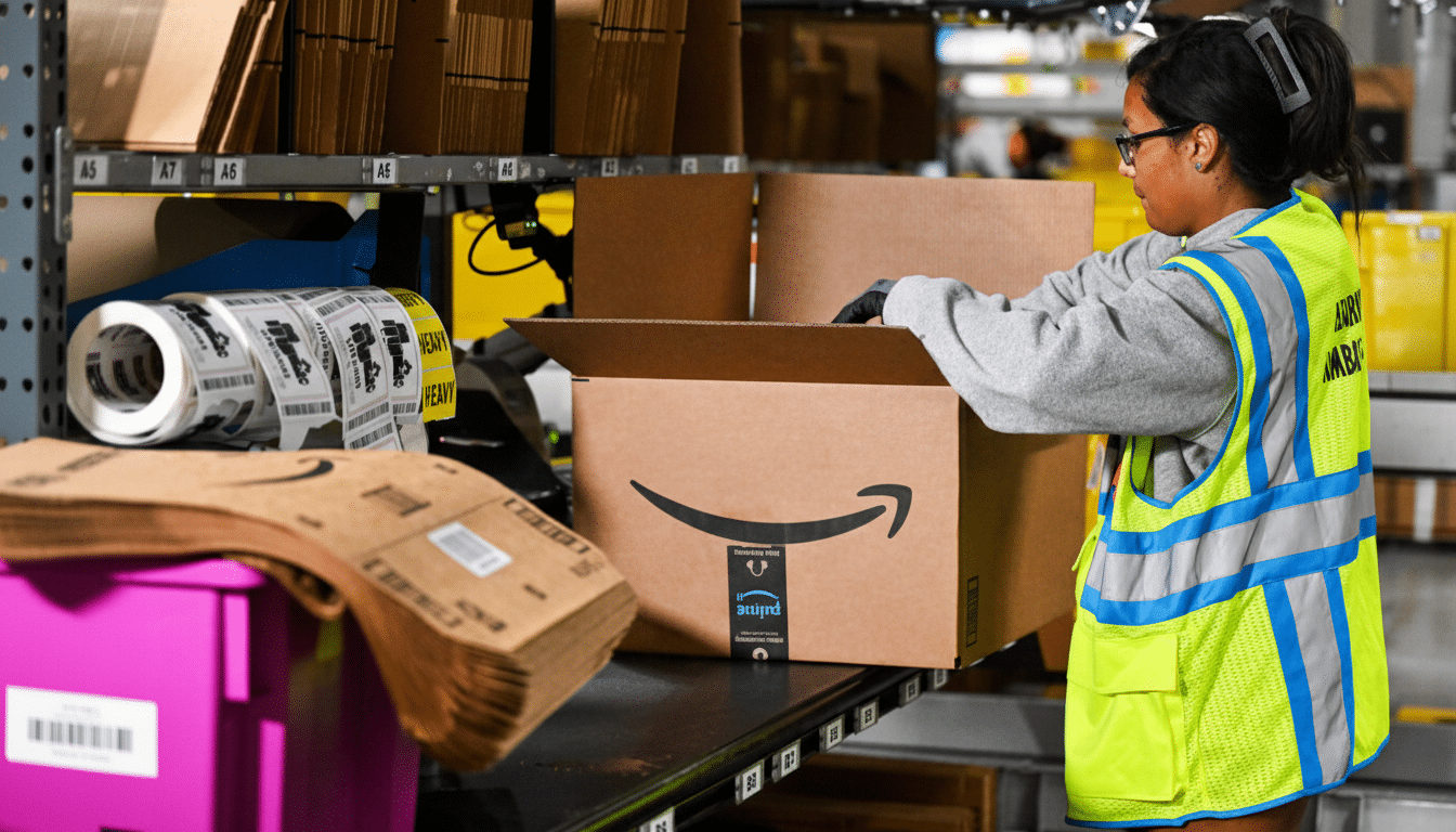 A woman in a neon yellow safety vest and glasses is packing an Amazon box in a warehouse.