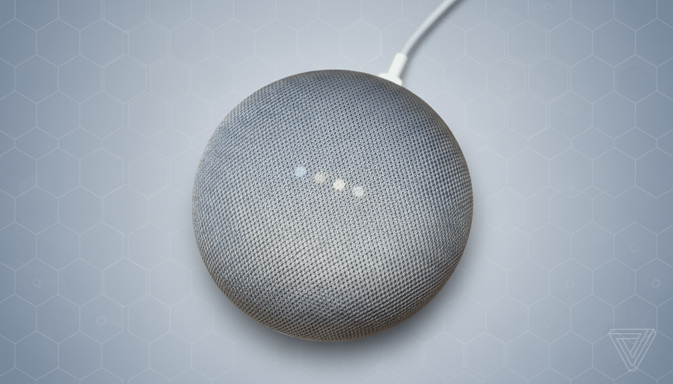 A gray Google Home Mini speaker with four colored lights on top, set against a professional light gray background with a subtle hexagonal pattern.