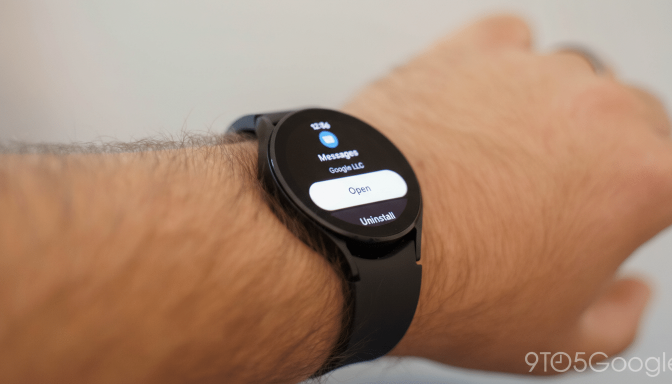 A close-up shot of a persons arm wearing a black smartwatch, displaying a notification for Messages from Google LLC with options to Open or Uninstall.