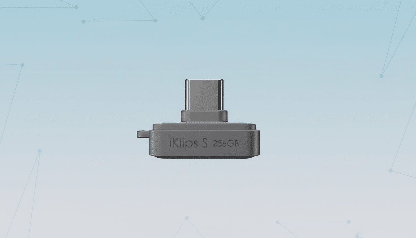 A gray iKlips S 256GB USB drive with a USB-C connector, presented on a light blue gradient background with subtle geometric patterns.