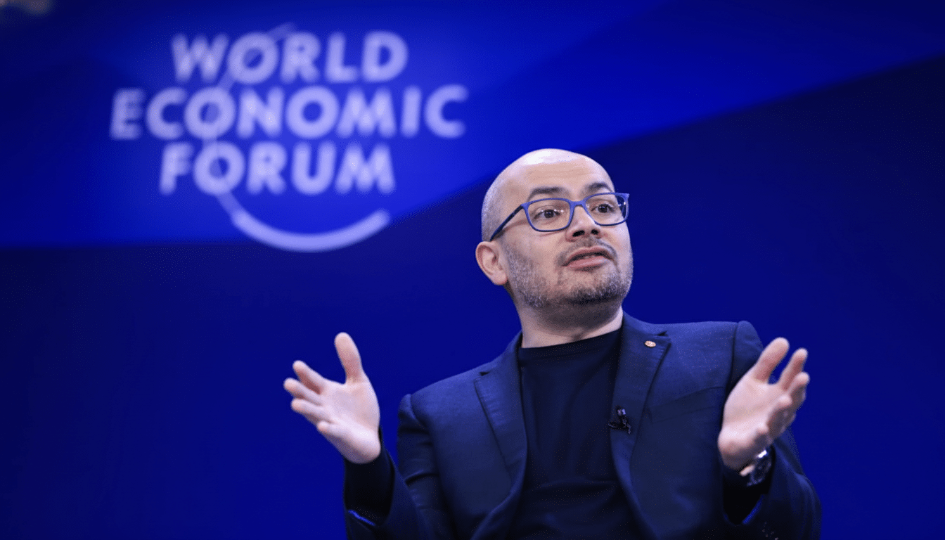A man with glasses and a beard speaking at the World Economic Forum.
